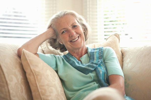 Mature woman smiling in chair | Applewood Independent